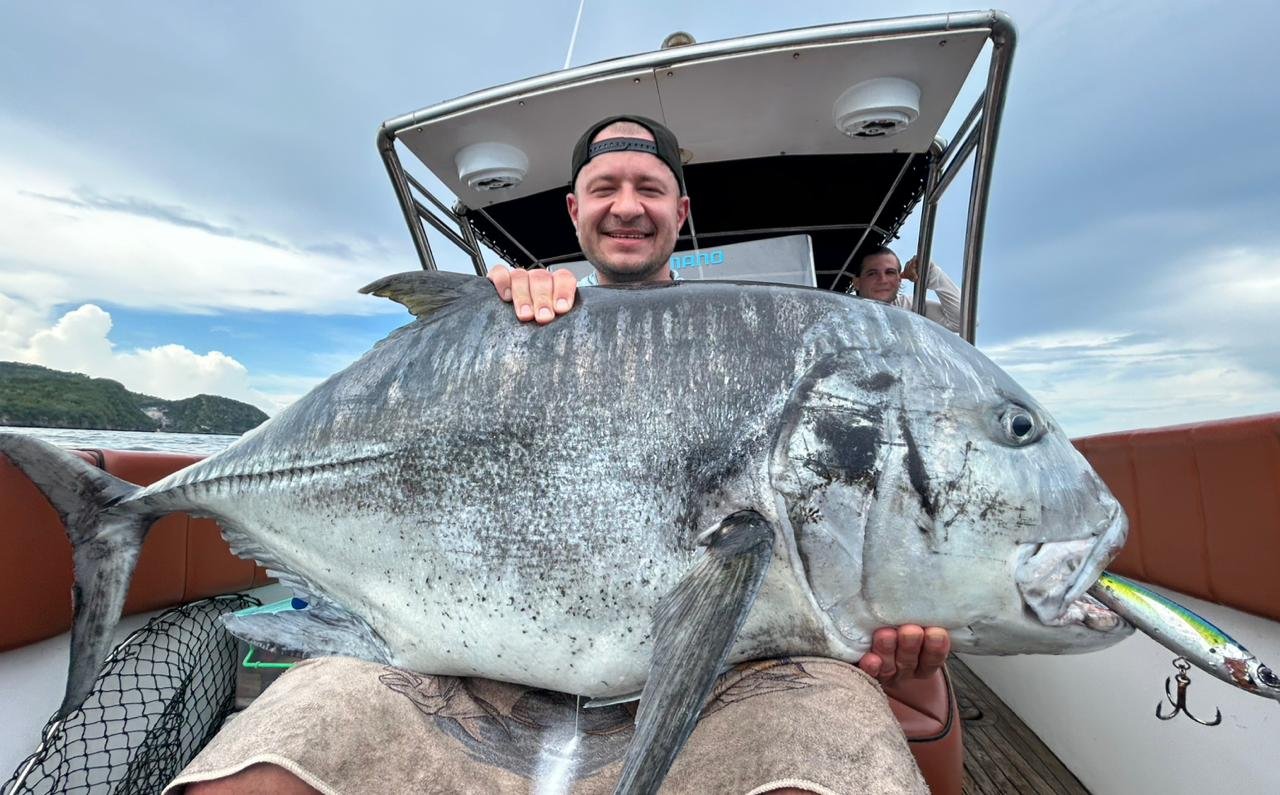 Angler holding giant amberjack during fishing trip in Nusa Penida