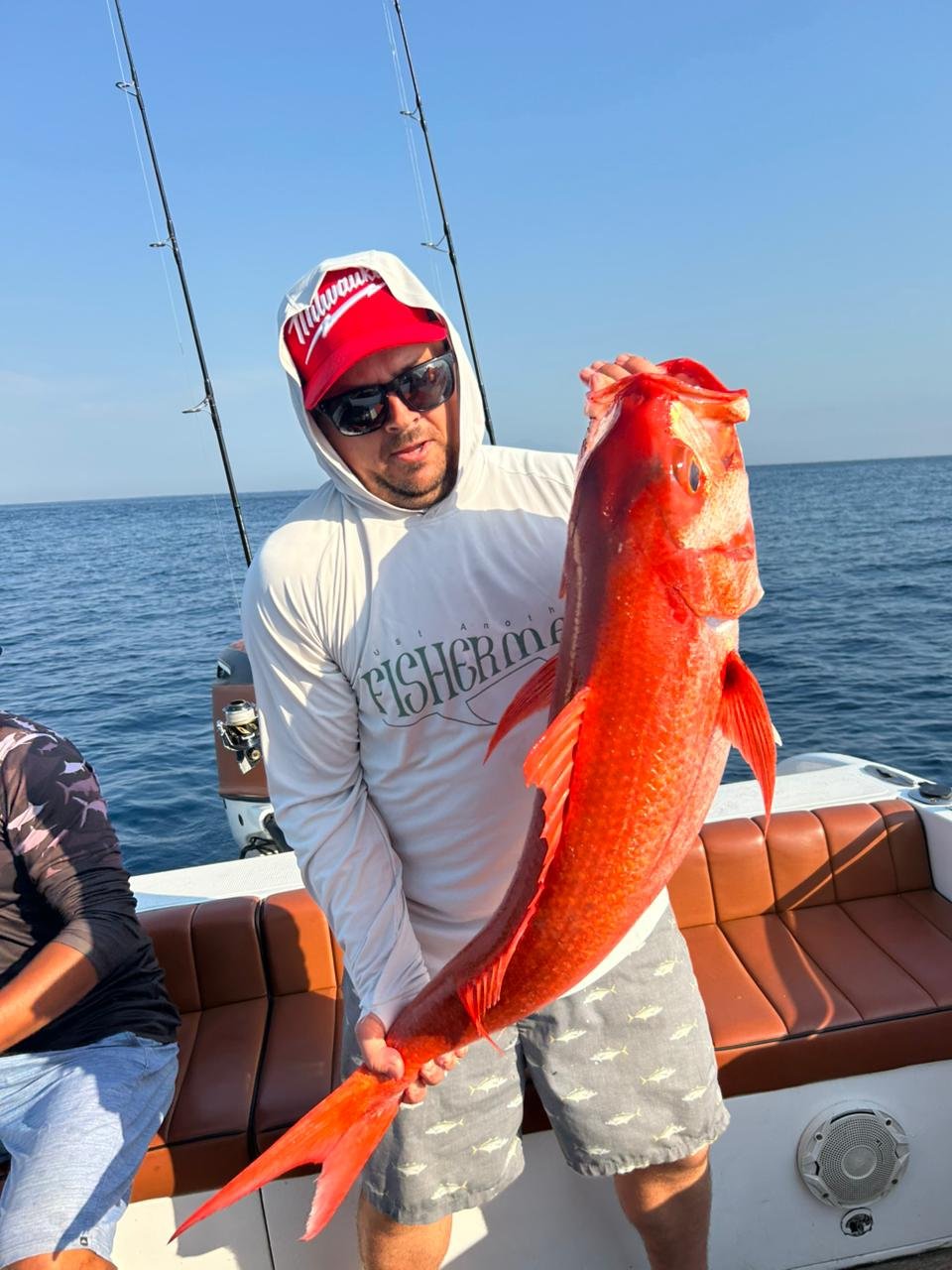 Angler holding giant amberjack during fishing trip in Nusa Penida